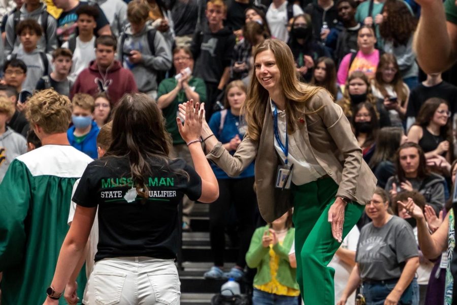 Mrs. Riggleman, the new head principal at MuHS, cheers on the 2021-2022 MuHS track members as they will be heading to states. 