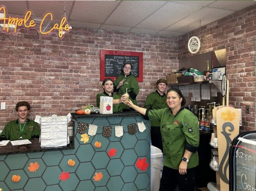 Pictured above are some of the Sweet Apple Cafe's managers and Mrs. Nauman on the right.